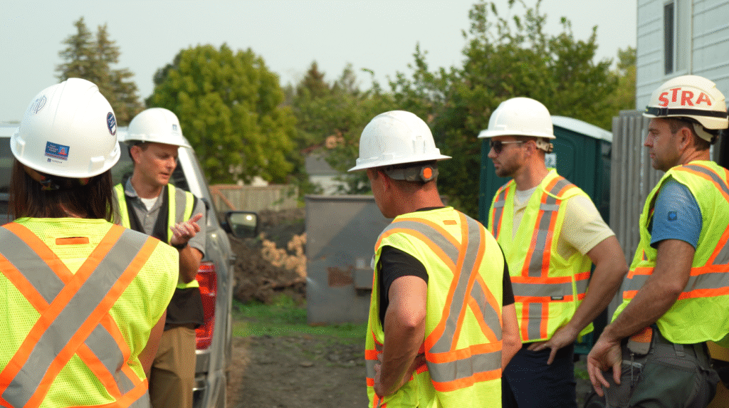 Superior Projects team discussing site details during a Manitoba construction meeting.